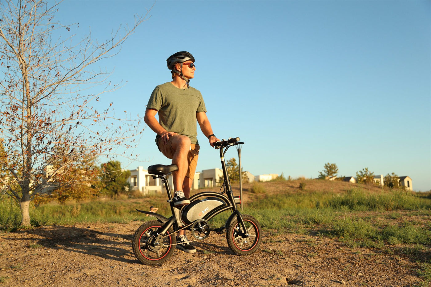 DYU D3+ Electric Bike with man wearing helmet going for a bike ride